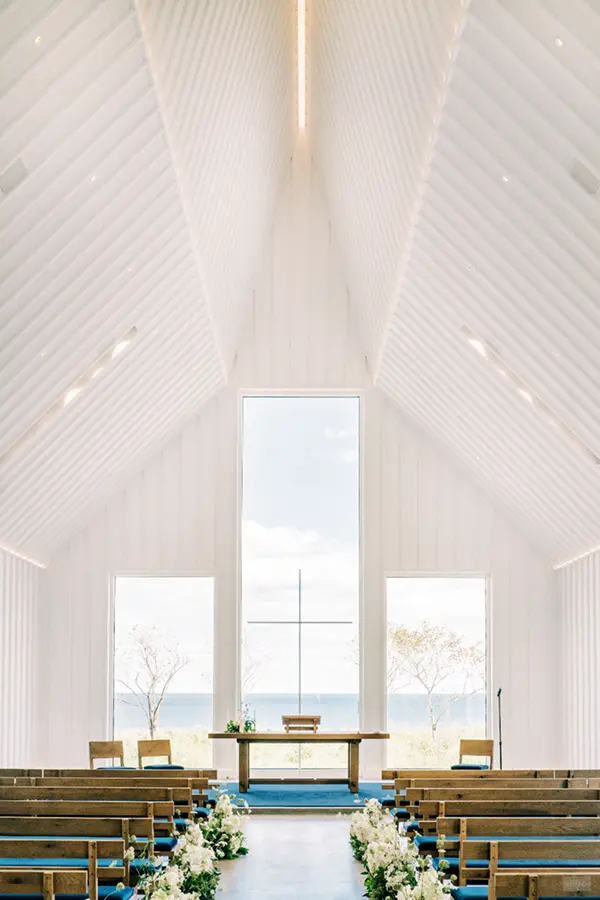 White chapel event space with vaulted ceiling and ocean view